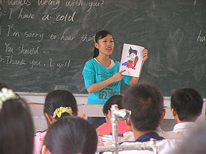 Student teacher in China teaching children Eng...